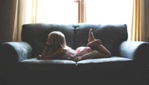 girl on couch in dim room