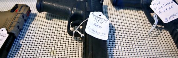 guns on table with price tags