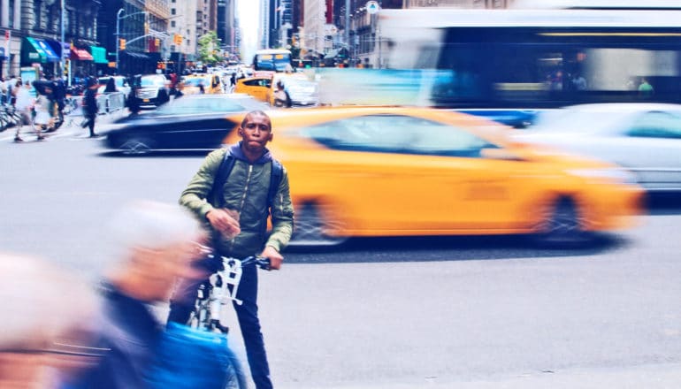 guy on bike in city traffic