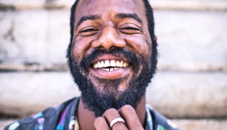 man smiling against wall