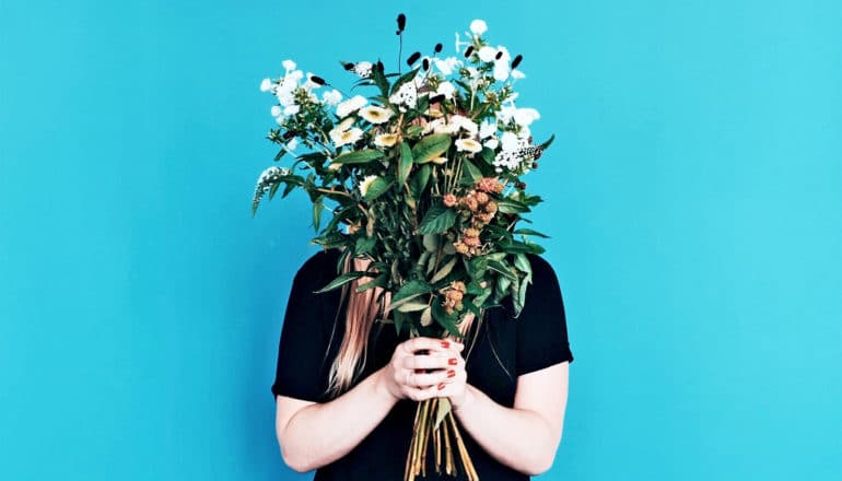 woman holding flowers up (brain activity concept)