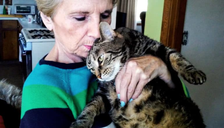 older woman holds cat