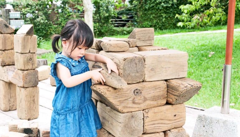 young girl playing with blocks (spatial reasoning concept)