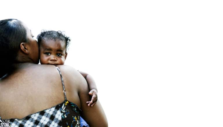 low-income mothers of color - baby looks over mom's shoulder