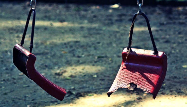 broken swing at playground