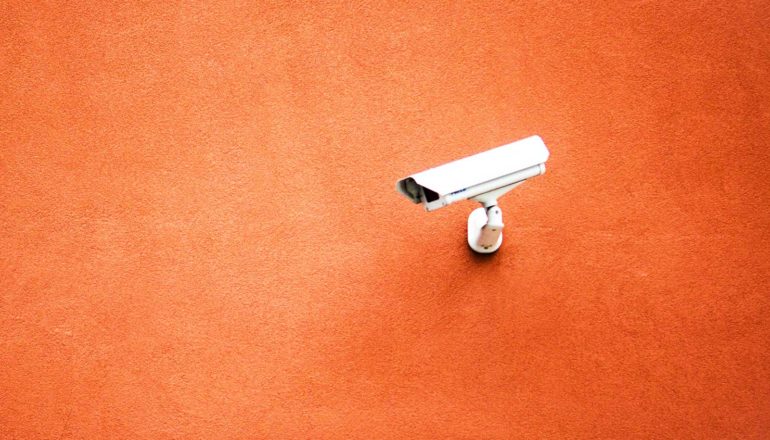 security camera on orange wall
