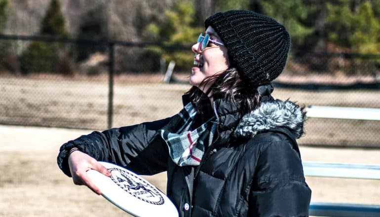 college student playing frisbee