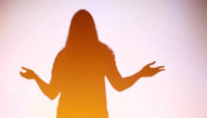 god encounter - warm silhouette of person with hands out