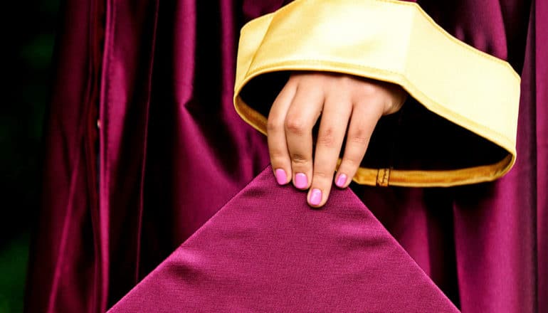 holding graduation cap