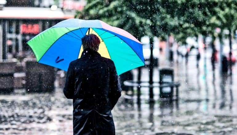 man with umbrella in the rain (organic solar cells concept)