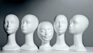 mannequin heads on a shelf