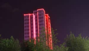 red neon lines on building in dark - redlined neighborhoods