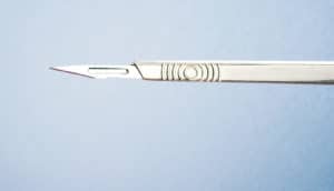 bariatric surgery - scalpel against blue background