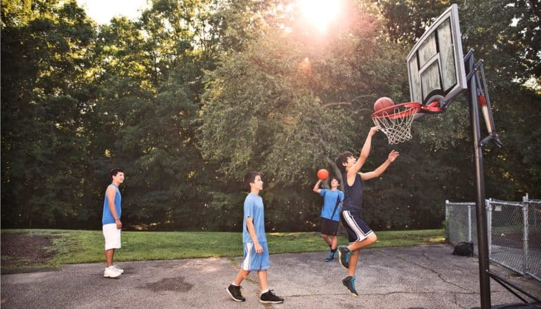 teen boys play basketball