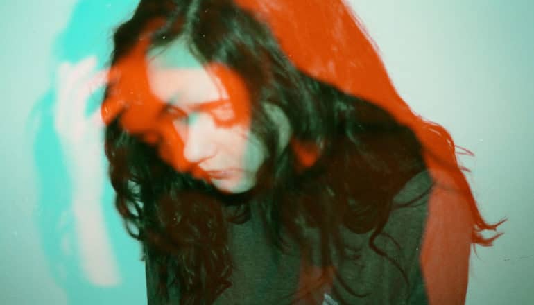 homophobic bullying - double exposure of sad teen girl in teal and red