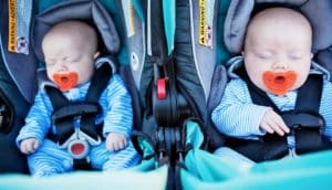 multiple births - twin babies in car seats with pacifiers