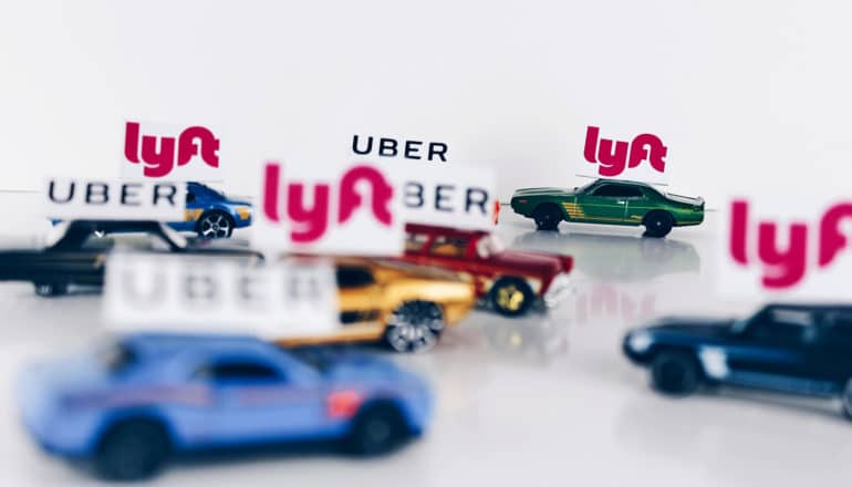 uber and lyft matchbox cars on white