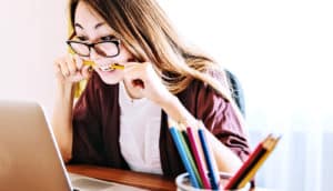 woman biting pencil