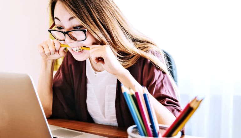 woman biting pencil