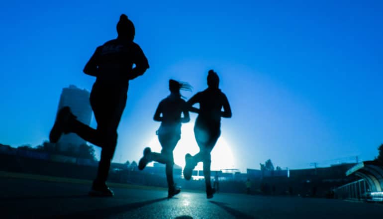 three figures running in blue