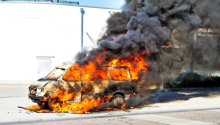 car on fire - armed conflict