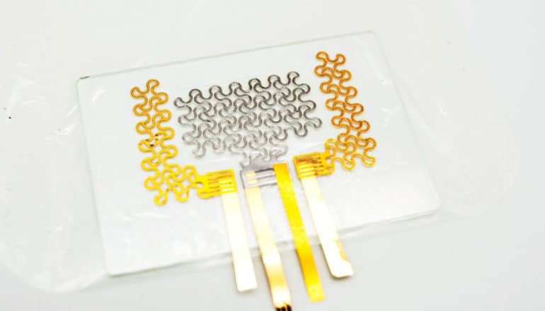 electronic tattoo -- gold and silver wires on clear rectangle
