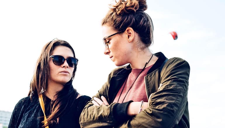 frustrated young women looking at each other (emotions concept)