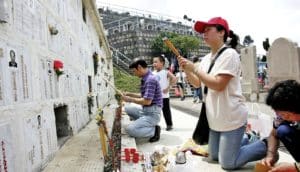 people at gravesites in Hong Kong