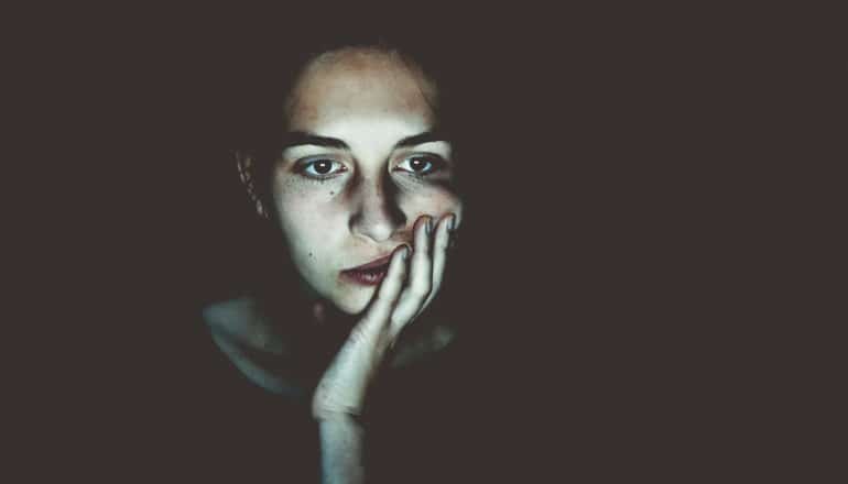 serious woman's face in dark