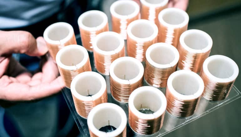 copper wire on white plastic tubes