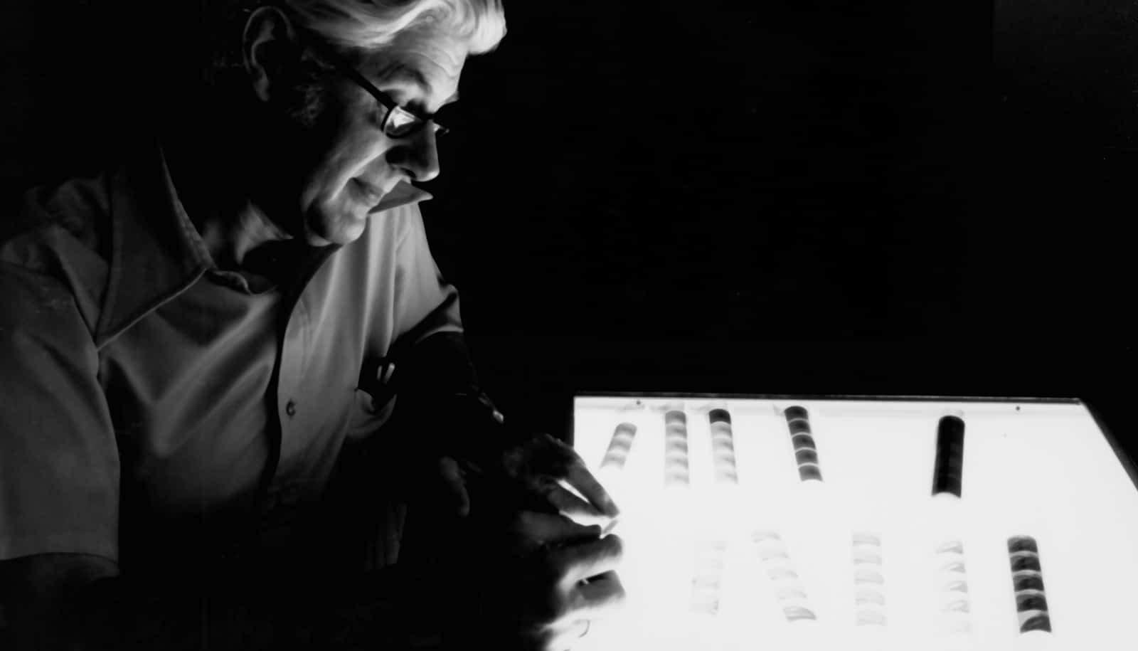 man looks at negatives on lightbox