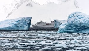 ship between icebergs in Antarctica