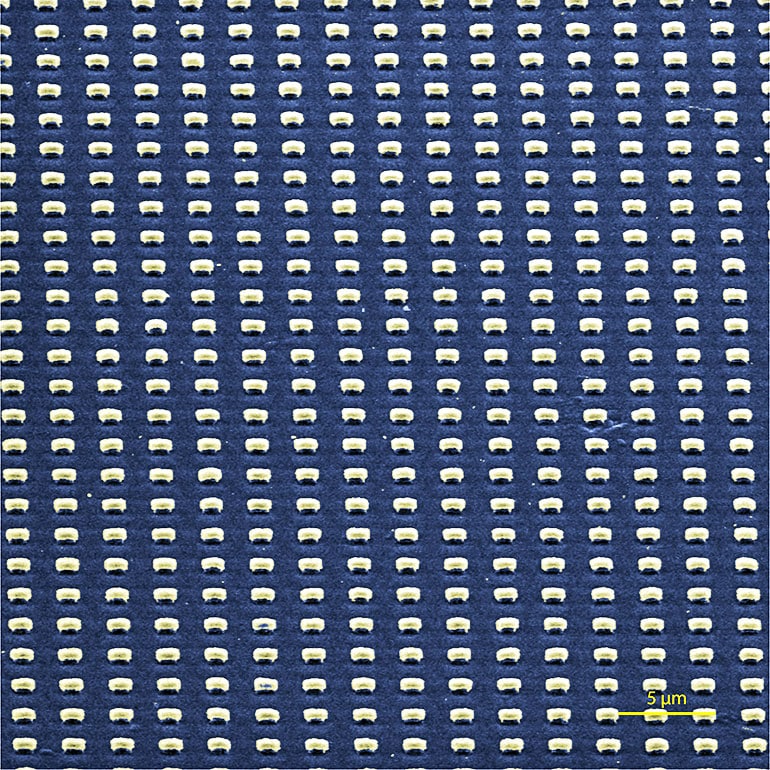 A scanning electron microscope image shows submicron-scale cavities patterned into films of aligned carbon nanotubes