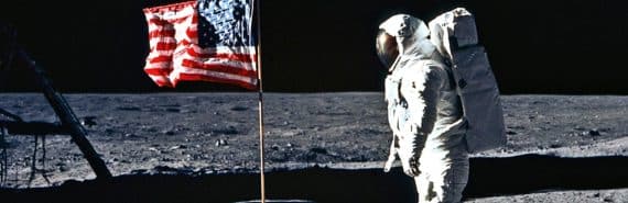 Astronaut looks at flag on the moon