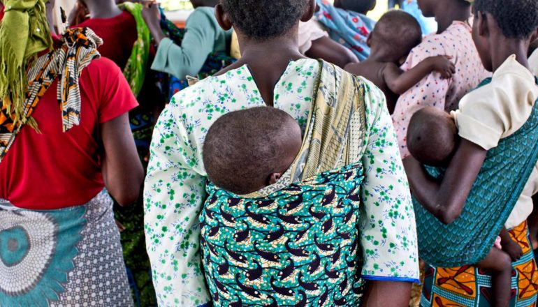moms wearing babies at clinic in Malawi