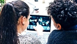 pair working over laptop (collective intelligence concept)