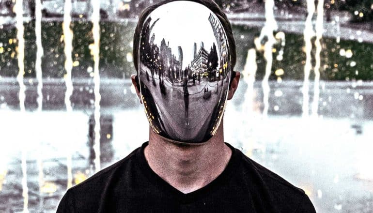 man wearing silver face mask (deepfake videos concept)