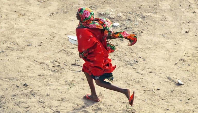 person in red running with bowl