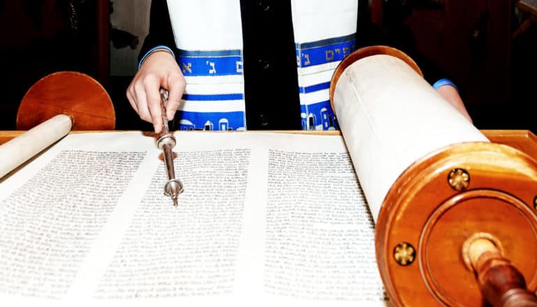 person reading Torah - American Judaism