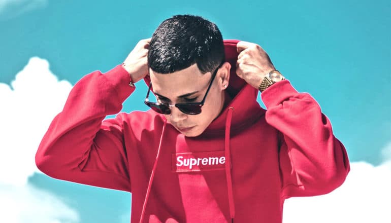 young man wearing Supreme hoodie (brands concept)