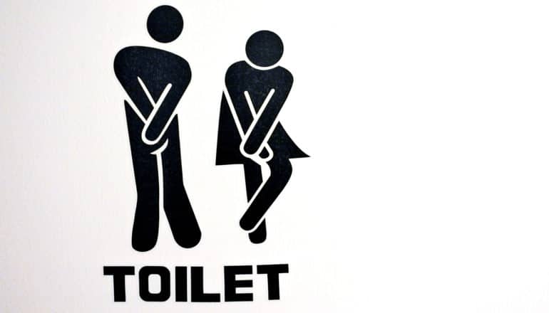 The stick figure people from bathroom signs double over in pain