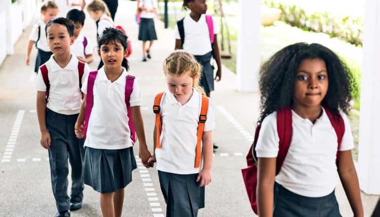 charter schools: kids in uniforms walk into school