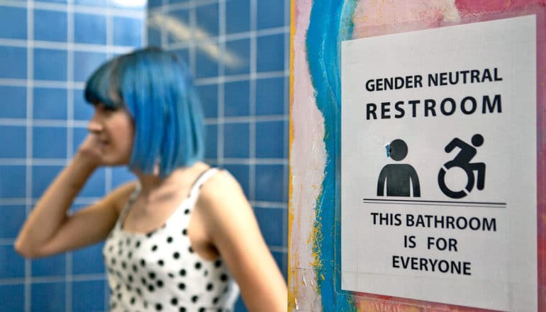 A non-binary femme in a gender neutral bathroom