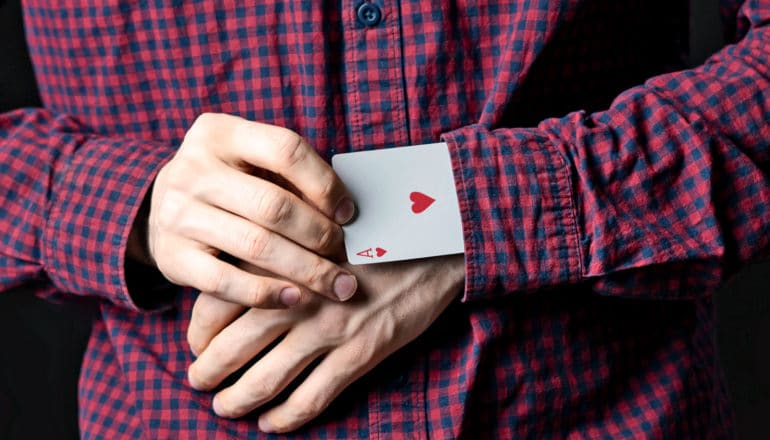 man with card up sleeve (cheating concept)