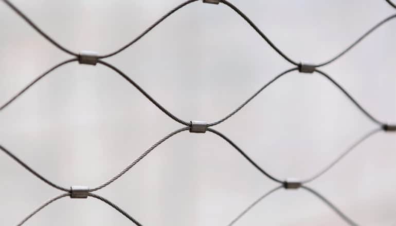 A chain link fence in black and white mimics the shape of the sensor