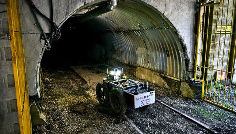 The image shows the robot entering a mine in Pennsylvania. (Subterranean Challenge concept)