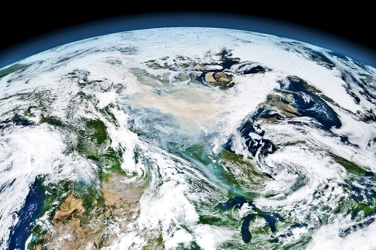 A mosaic image of several satellite overpasses capture the global scope of the wildfire smoke cloud. 