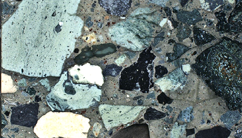 A cross-section shows rocks of various colors 