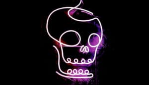 pink neon skull on black background