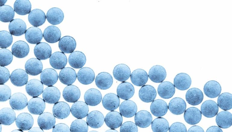 blue pills arranged to create a downward slope